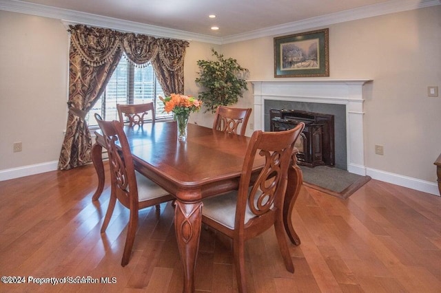 dining space featuring hardwood / wood-style flooring and crown molding