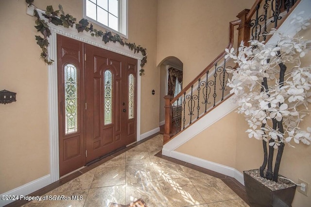 entrance foyer featuring a towering ceiling