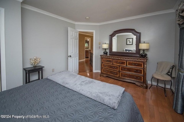 bedroom featuring hardwood / wood-style floors and ornamental molding