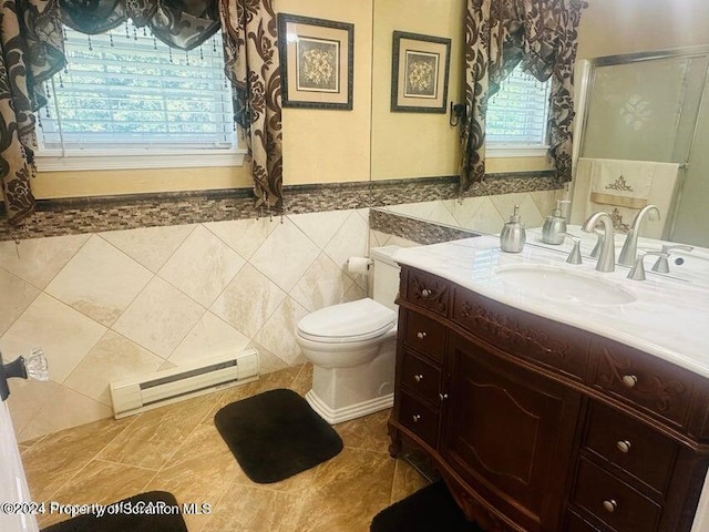 bathroom with vanity, tile patterned flooring, toilet, baseboard heating, and tile walls