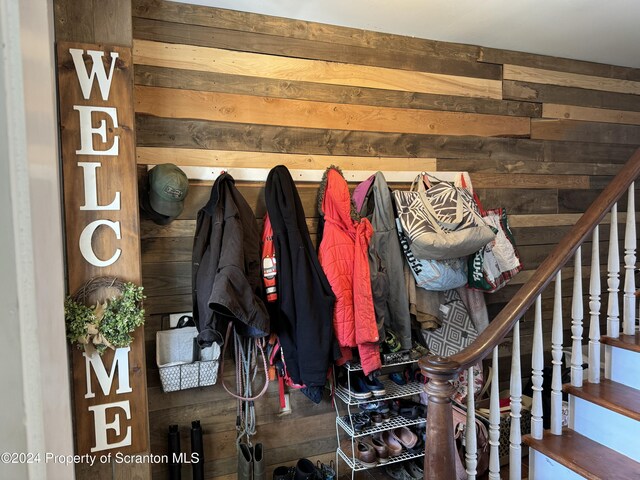 mudroom featuring wood walls