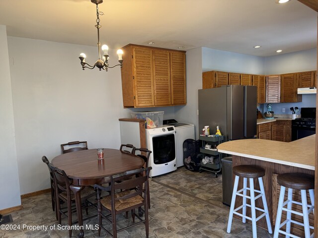 kitchen featuring stone finish floor, light countertops, black gas stove, and under cabinet range hood