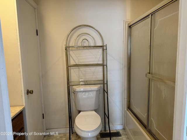 full bathroom featuring toilet, bath / shower combo with glass door, vanity, and visible vents