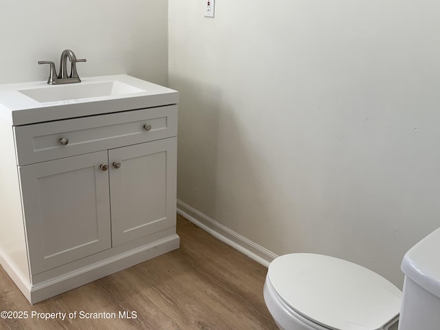 bathroom featuring vanity, toilet, and wood-type flooring