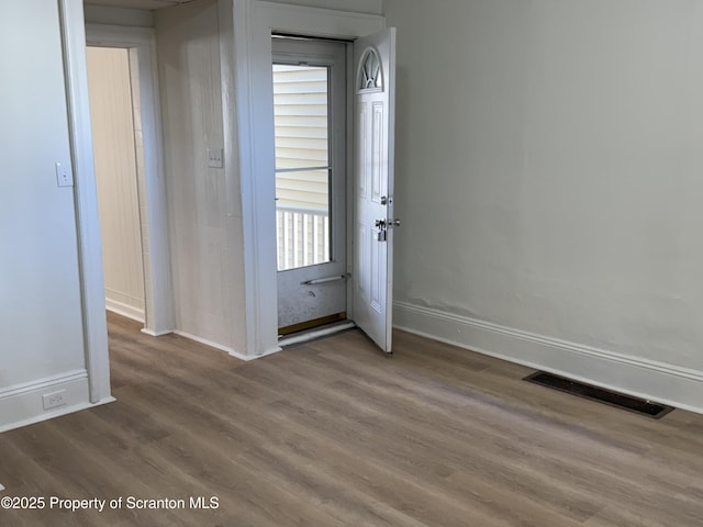 entryway with hardwood / wood-style floors