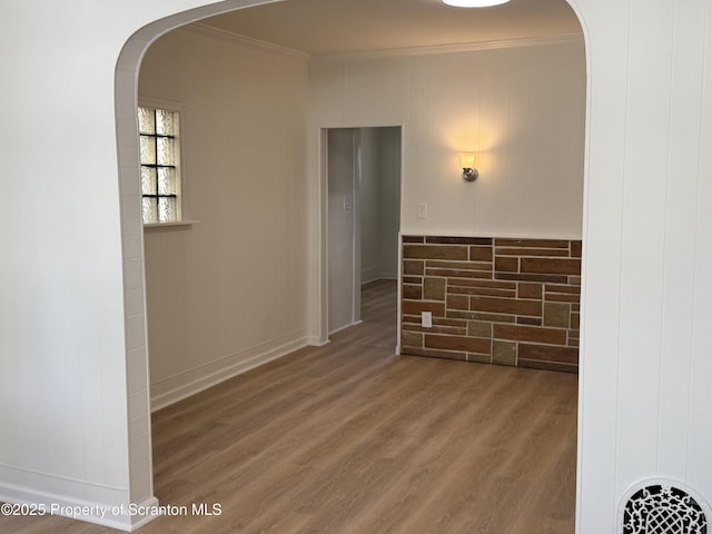 hallway with crown molding and wood-type flooring