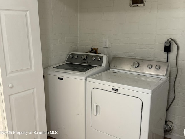 clothes washing area featuring washer and dryer