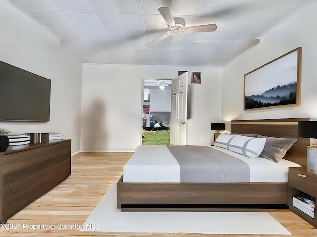 bedroom featuring crown molding, light hardwood / wood-style flooring, and ceiling fan