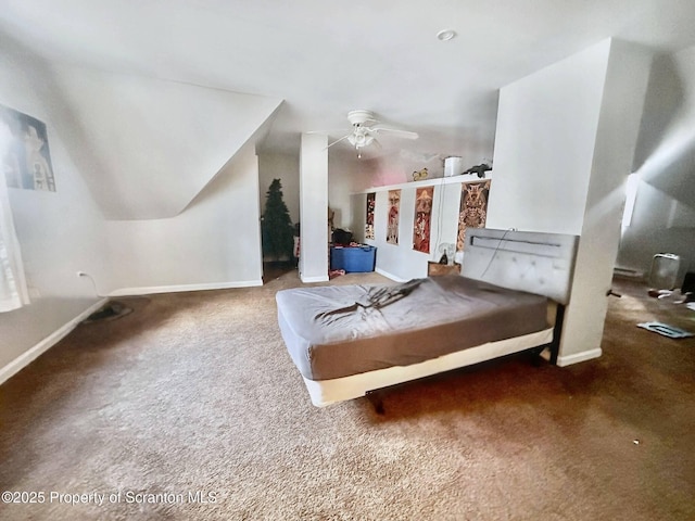 bedroom featuring dark carpet, vaulted ceiling, and ceiling fan