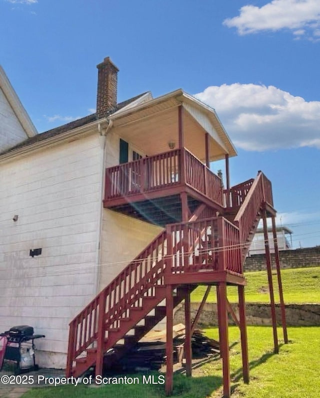 exterior space with a balcony and a lawn