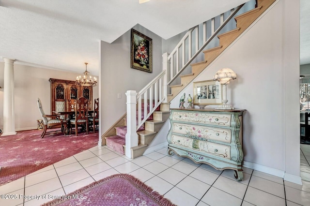 stairs featuring carpet floors, a notable chandelier, baseboards, and tile patterned floors