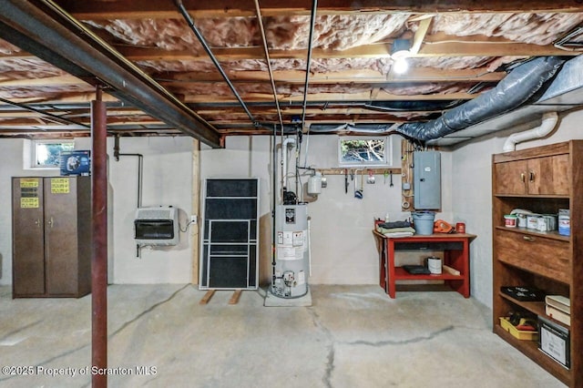 below grade area featuring heating unit, electric panel, and gas water heater