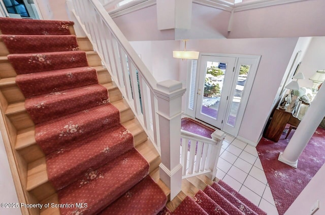 entryway with light tile patterned floors and stairway