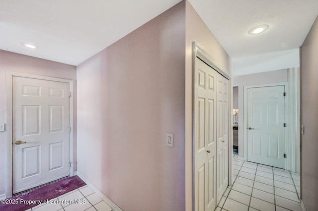 hall with light tile patterned floors, recessed lighting, and baseboards