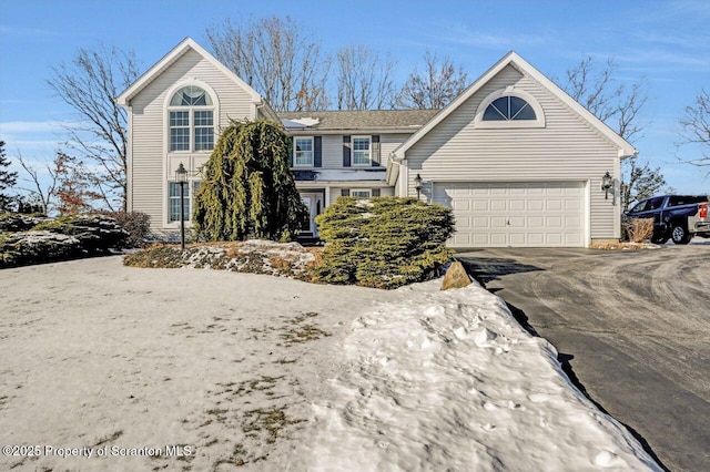 view of front of home with driveway and an attached garage