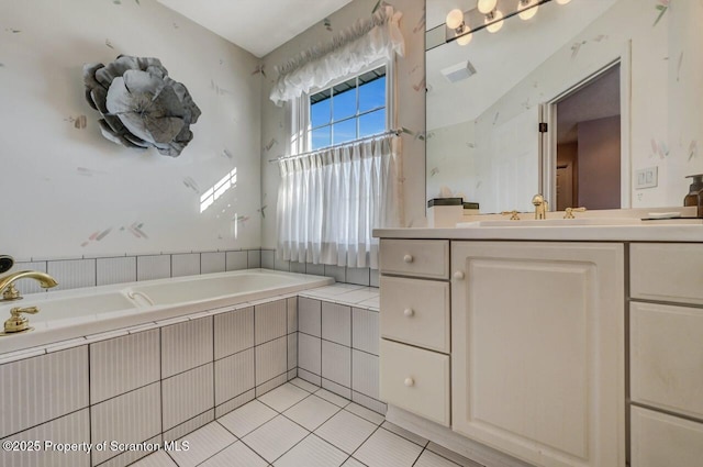 full bath featuring tiled tub, visible vents, vanity, and tile patterned floors