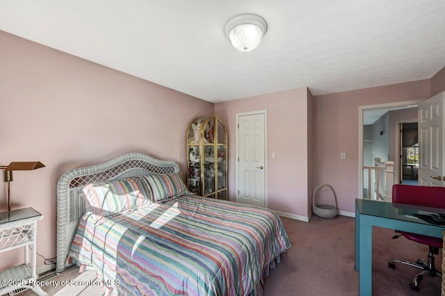 bedroom featuring carpet and baseboards