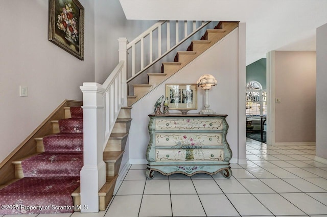 stairs featuring baseboards and tile patterned floors