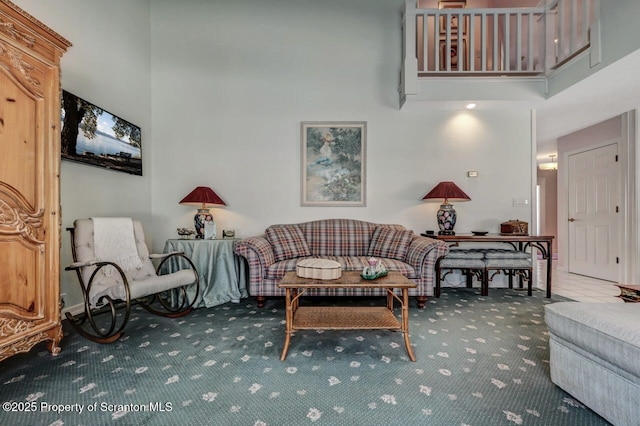 carpeted living room featuring a high ceiling