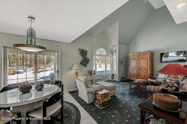 interior space featuring a textured ceiling, high vaulted ceiling, light tile patterned flooring, and baseboards