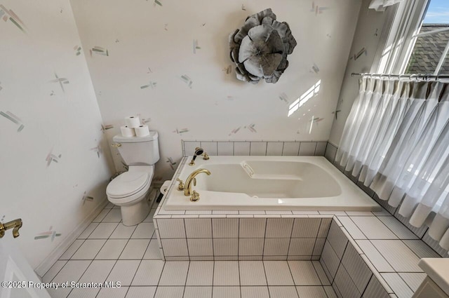 full bathroom featuring toilet, a bath, and tile patterned floors