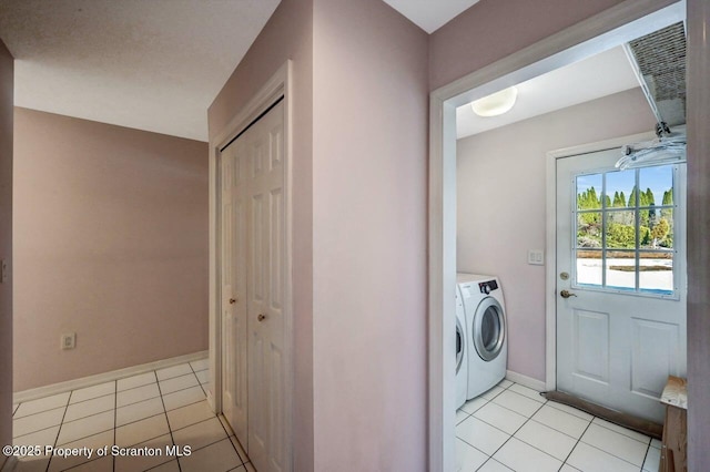 clothes washing area featuring laundry area, light tile patterned floors, baseboards, and independent washer and dryer