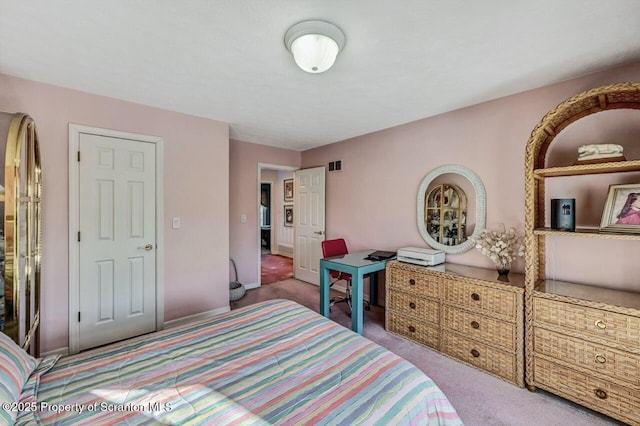 carpeted bedroom featuring visible vents