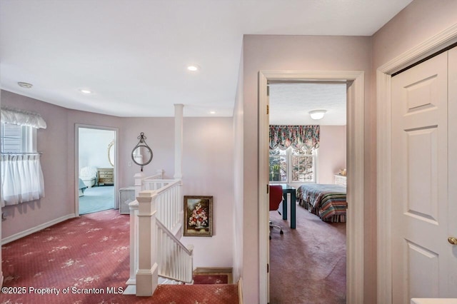 hall featuring recessed lighting, carpet, baseboards, and an upstairs landing