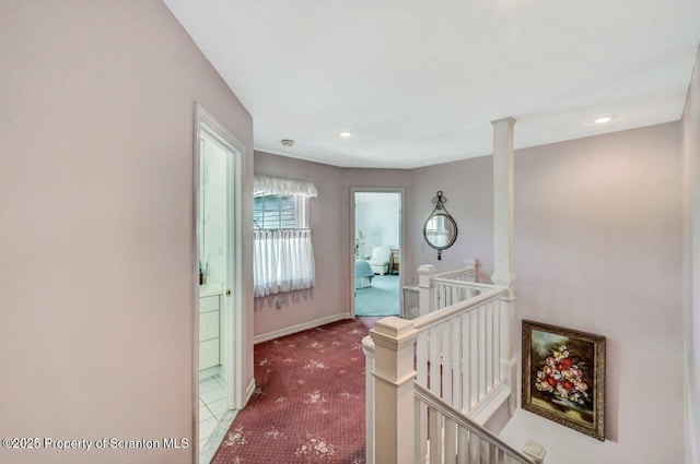 hallway with recessed lighting, baseboards, carpet flooring, and an upstairs landing