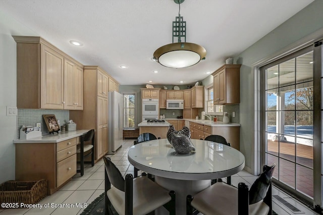 dining space featuring a healthy amount of sunlight, recessed lighting, and light tile patterned flooring