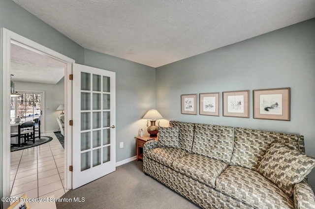 living room featuring french doors, light tile patterned floors, light carpet, a textured ceiling, and baseboards