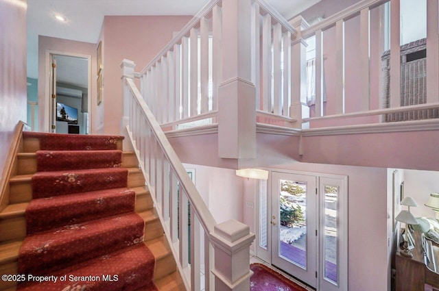 staircase with a high ceiling