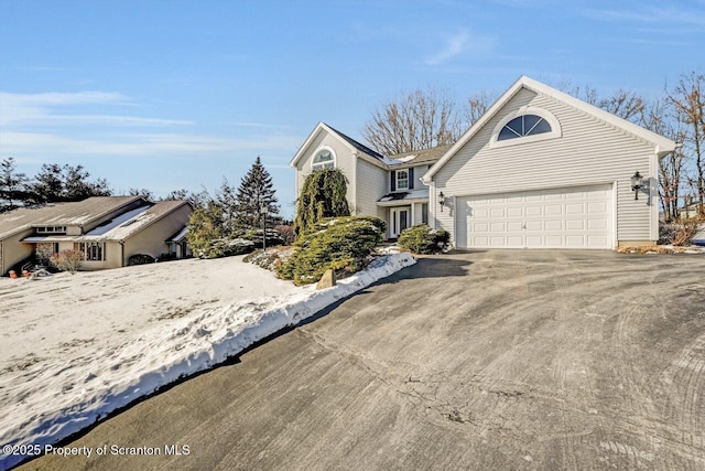 view of front of home featuring driveway and a garage