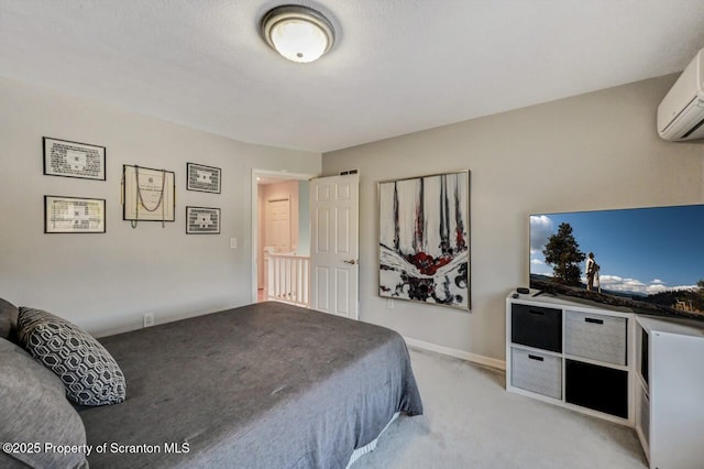 bedroom with light carpet, a wall mounted air conditioner, and baseboards