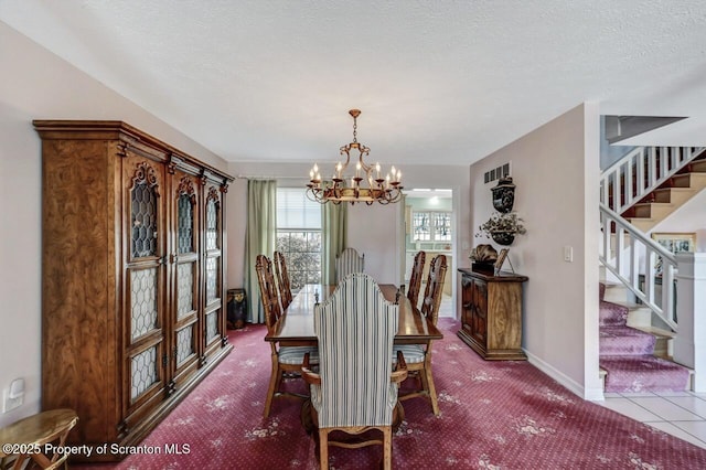 dining space featuring stairway, baseboards, a chandelier, and a textured ceiling