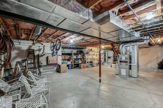 unfinished basement featuring heating unit