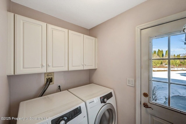 clothes washing area with cabinet space and separate washer and dryer