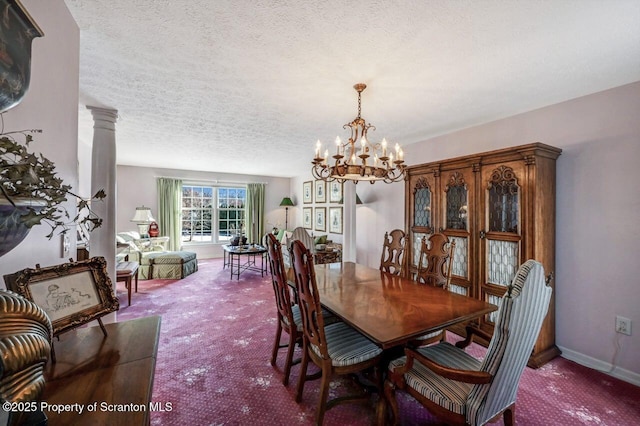 carpeted dining space with an inviting chandelier, decorative columns, baseboards, and a textured ceiling