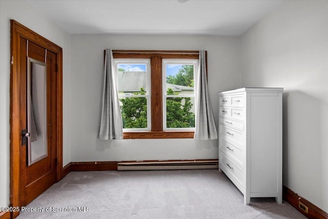820 Cherry St, Scranton, PA 18505 - unfurnished bedroom with a baseboard heating unit and light colored carpet