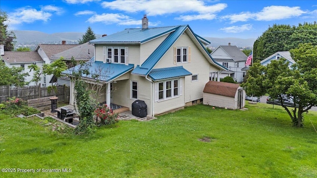 820 Cherry St, Scranton, PA 18505 - back of property featuring a chimney, a storage shed, a metal roof, and a mountain view