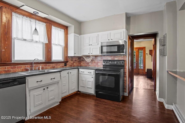 820 Cherry St, Scranton, PA 18505 - kitchen featuring appliances with stainless steel finishes, dark countertops, dark wood finished floors, backsplash, and white cabinets