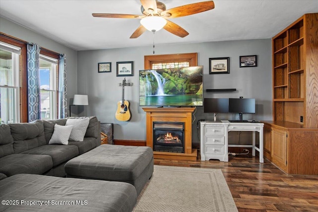 820 Cherry St, Scranton, PA 18505 - living area featuring dark wood-style floors, a ceiling fan, a desk, and a glass covered fireplace