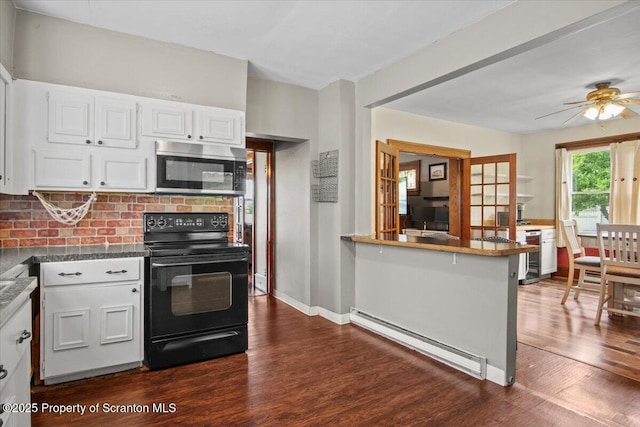 820 Cherry St, Scranton, PA 18505 - kitchen featuring black / electric stove, stainless steel microwave, a baseboard radiator, dark wood-type flooring, and white cabinets