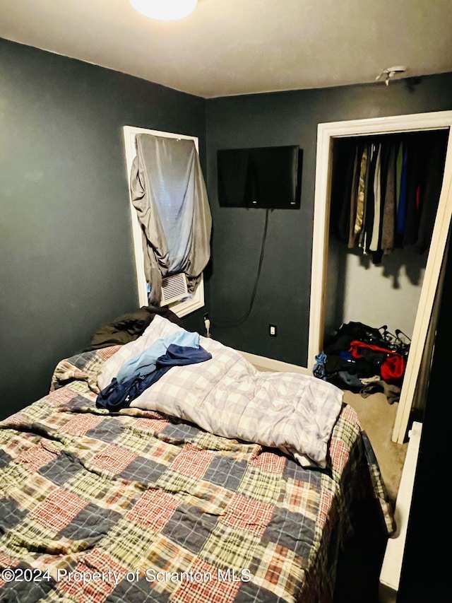 carpeted bedroom featuring a closet and cooling unit