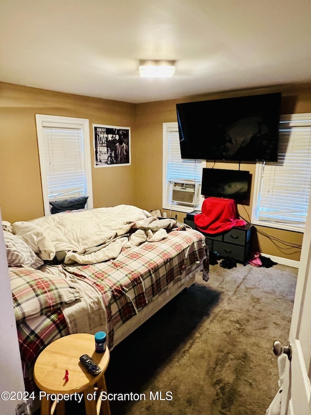 bedroom featuring carpet and cooling unit