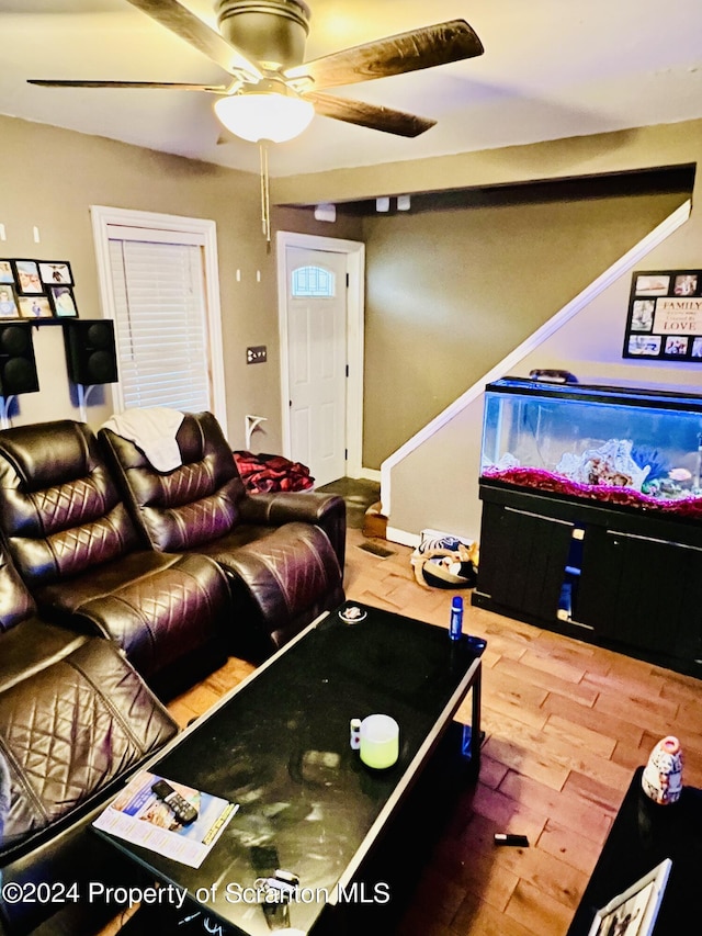 living room with ceiling fan and hardwood / wood-style flooring