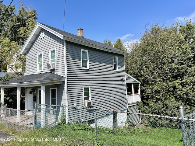 view of side of property with a yard and cooling unit