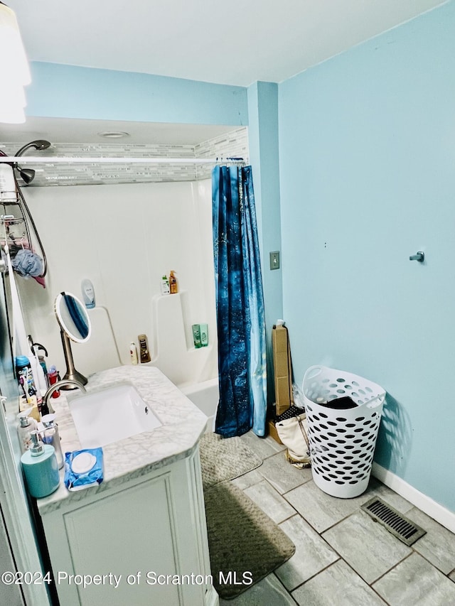 interior space with light tile patterned floors and sink