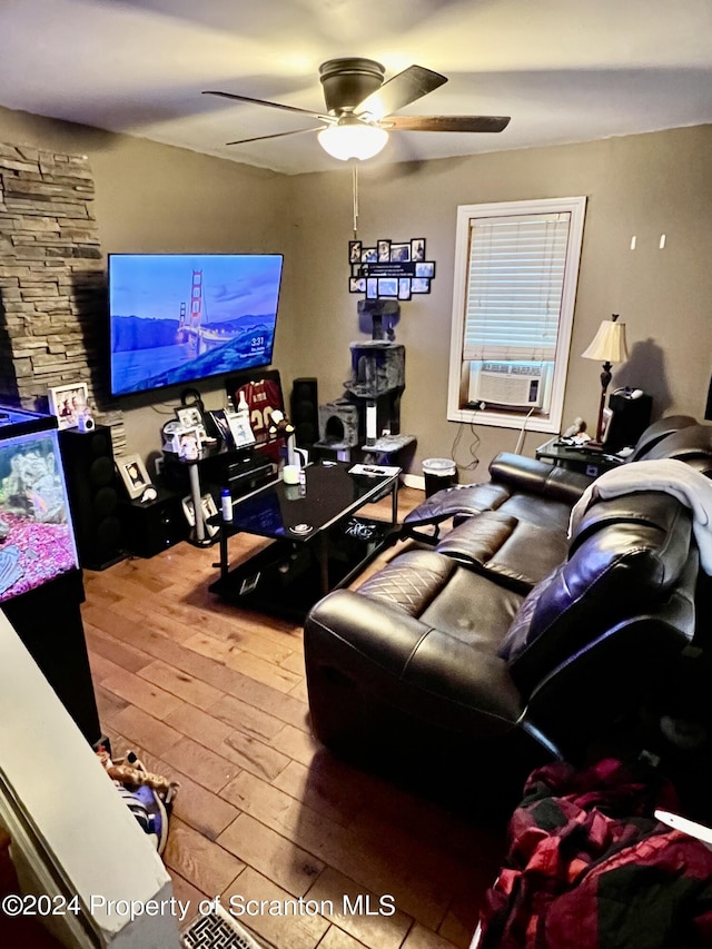 living room with hardwood / wood-style floors, ceiling fan, and cooling unit