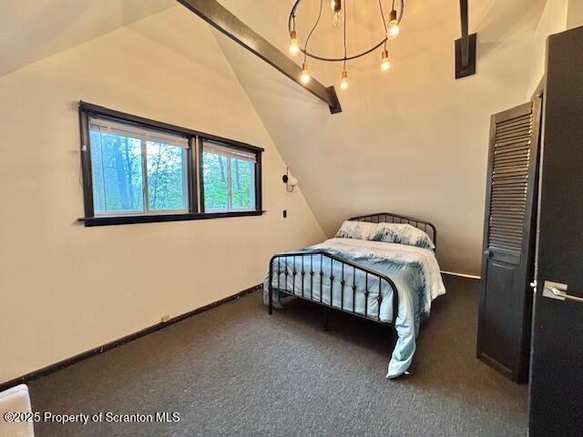 1717 Rolling Hills Dr, Tobyhanna, PA 18466 - bedroom featuring lofted ceiling, carpet floors, and a chandelier